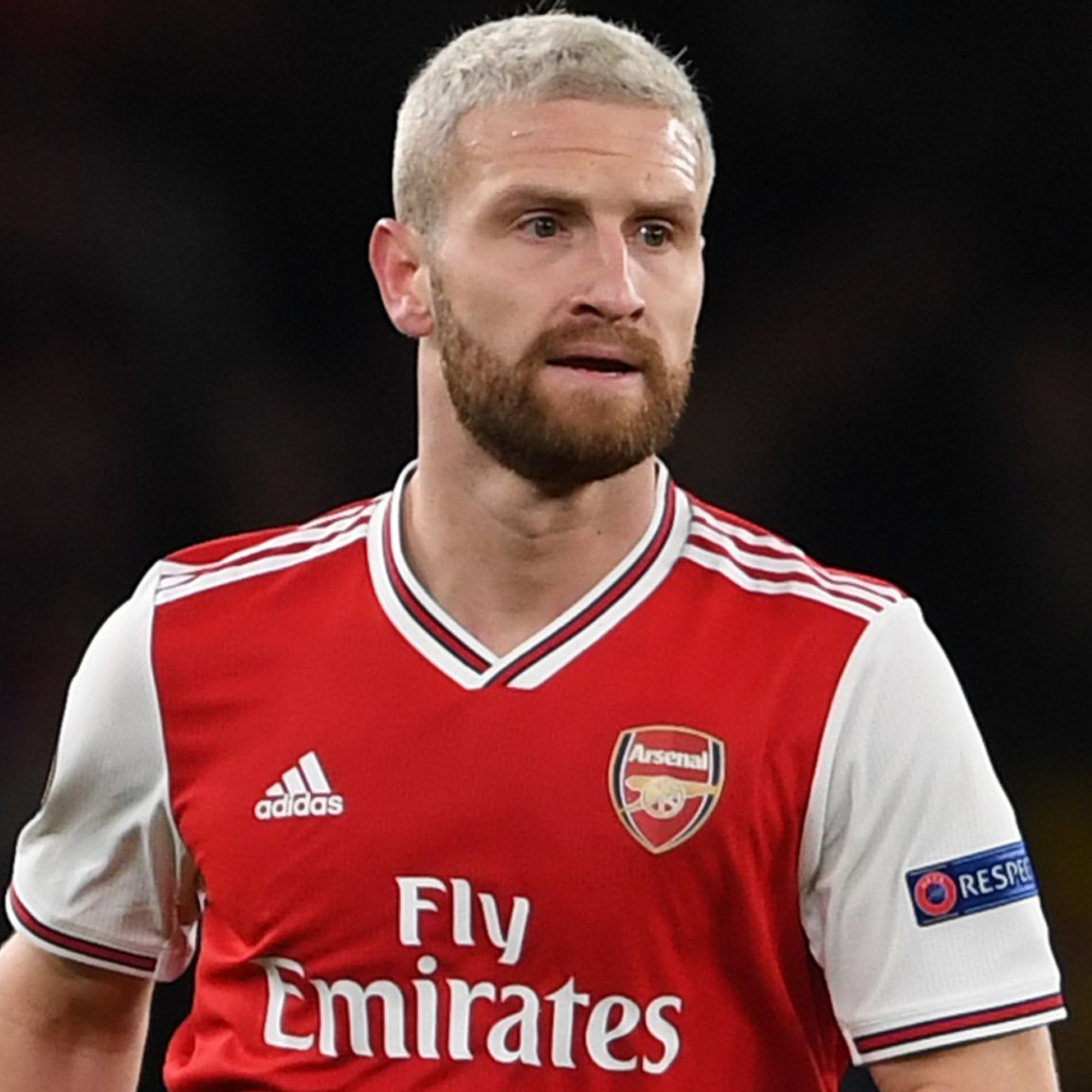 Footballer Mustafi wearing a red and white sports jersey